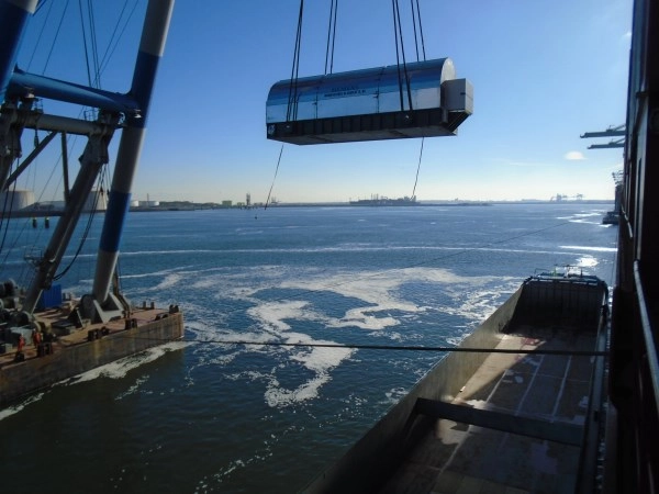 Heavy cargo is loaded with a crane